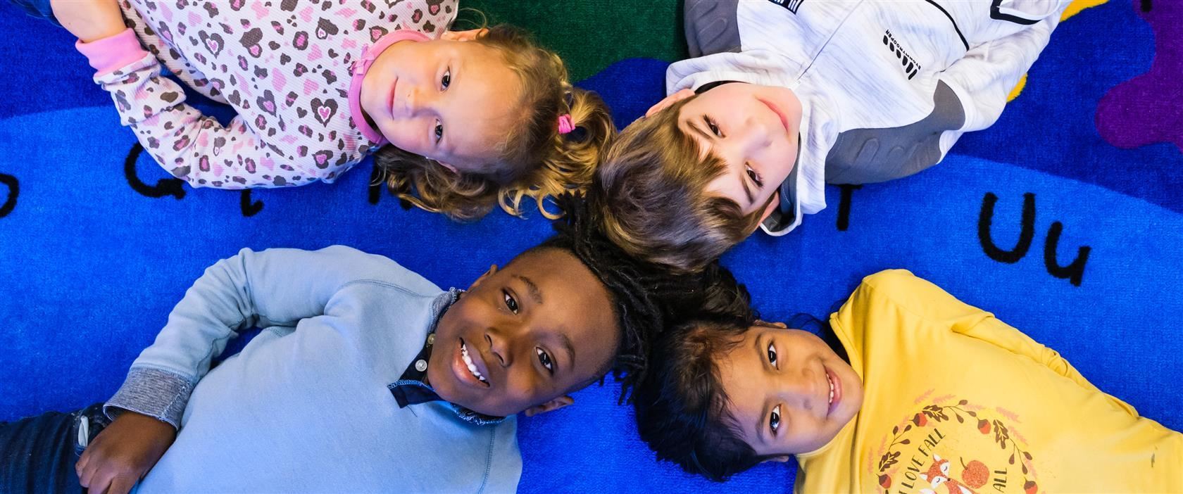 four children smiling at the camera